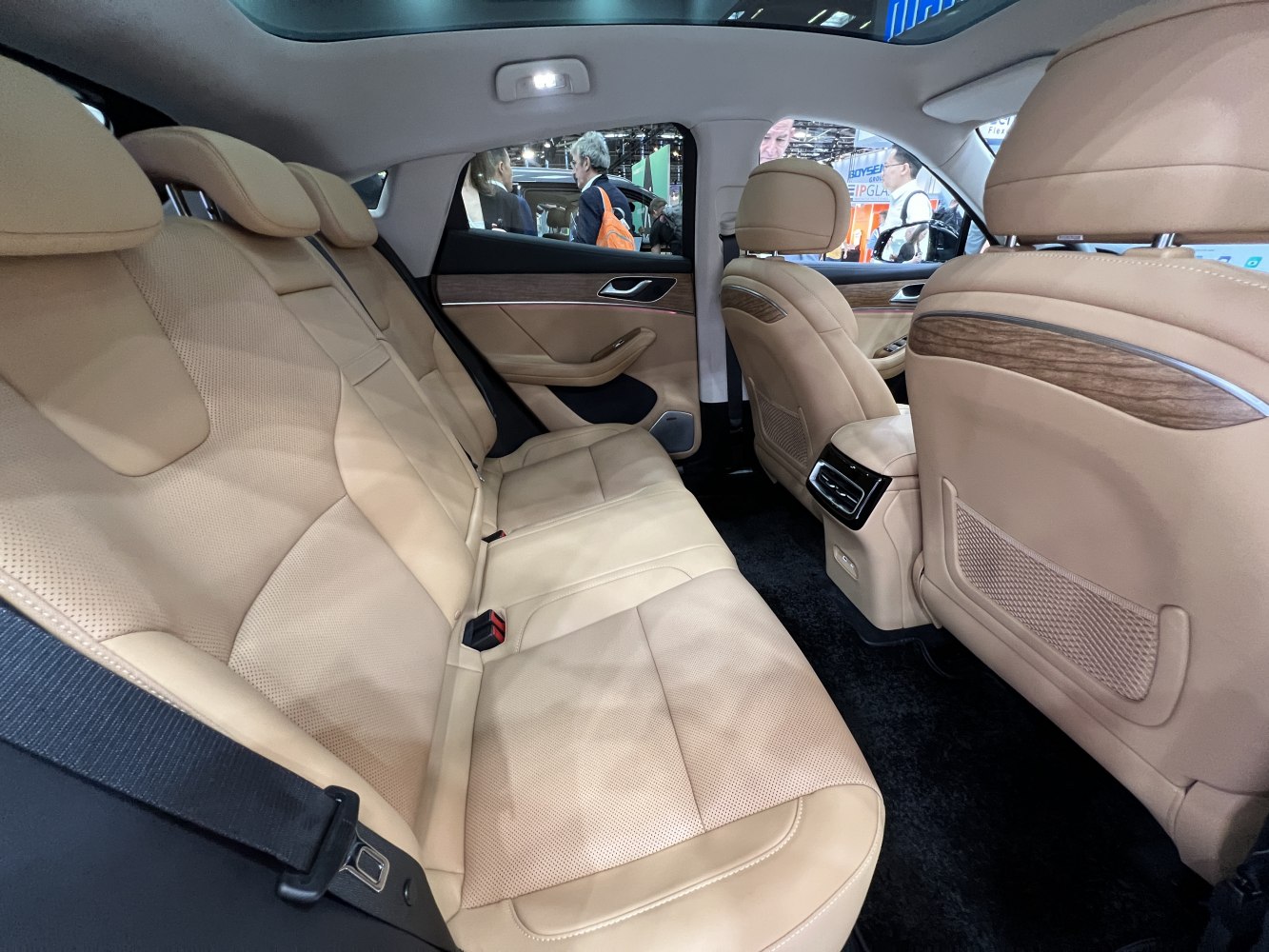 Beige leather rear seats with wood trim and rear air vents