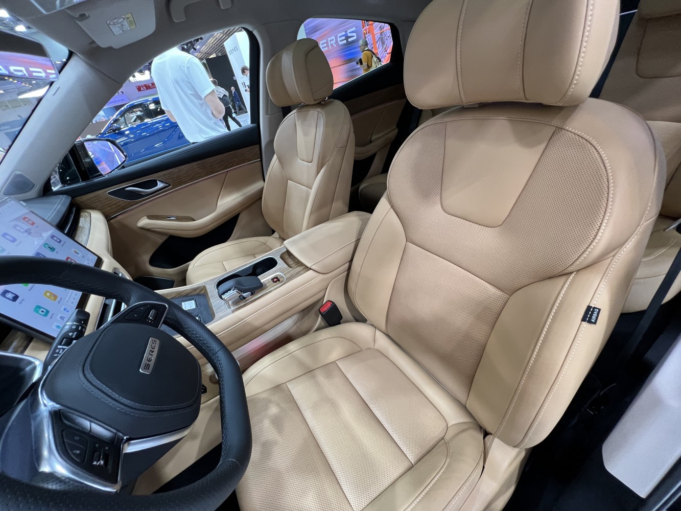 Luxury beige leather seats with wood trim and touchscreen dashboard