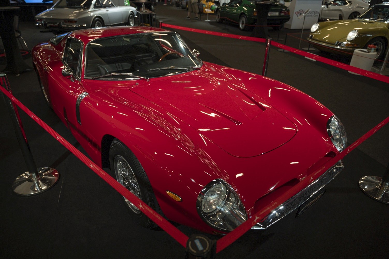 Sleek sports coupe with wire wheels and aerodynamic curved body.