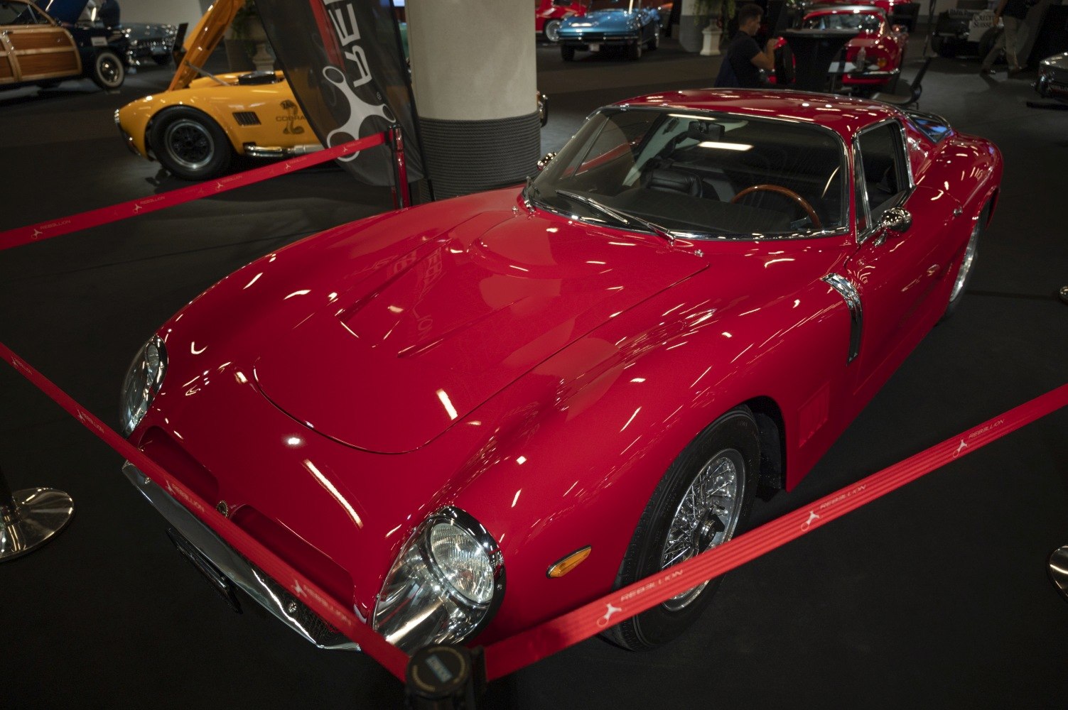 Red vintage sports coupe with aerodynamic curves and wire-spoke wheels
