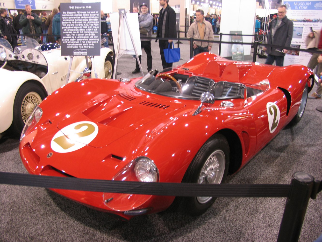 Open cockpit vintage racing car with number 2 badge and aerodynamic body design.
