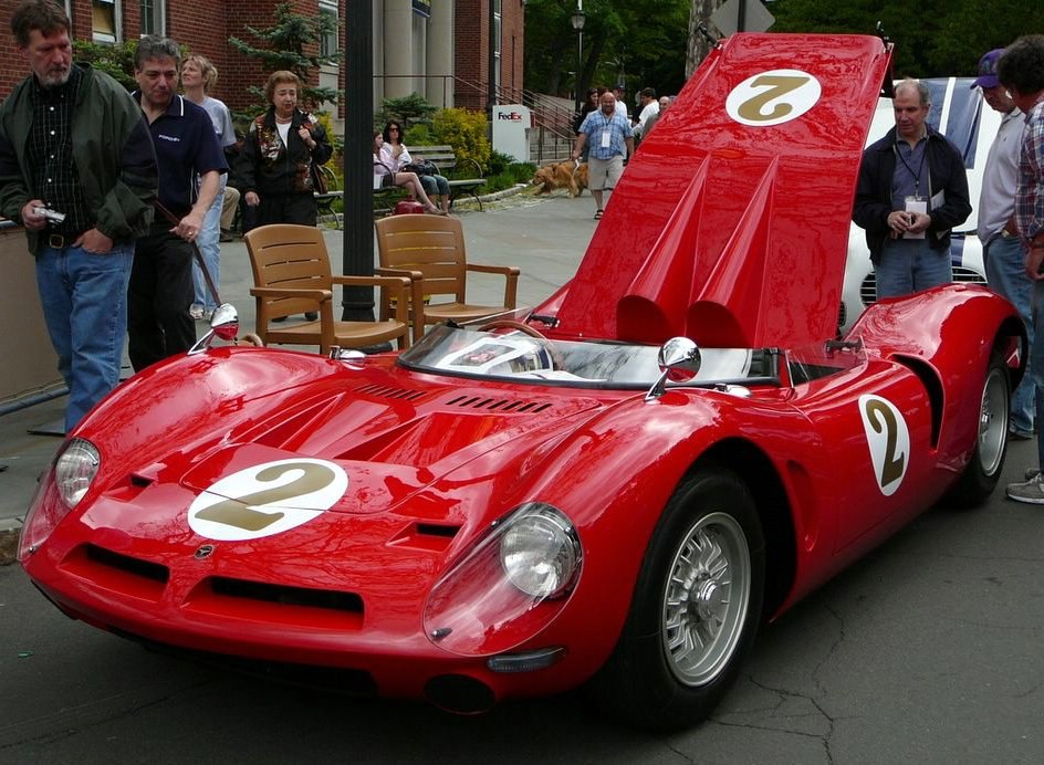 Red 1960s race car with number 2 decals and raised rear deck lid