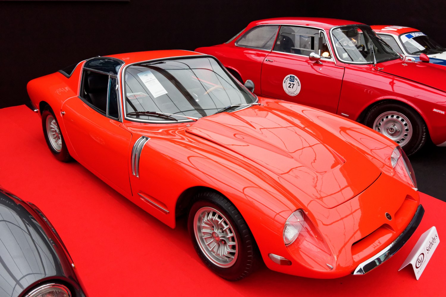 Sleek 1960s sports coupe with smooth lines and side vents