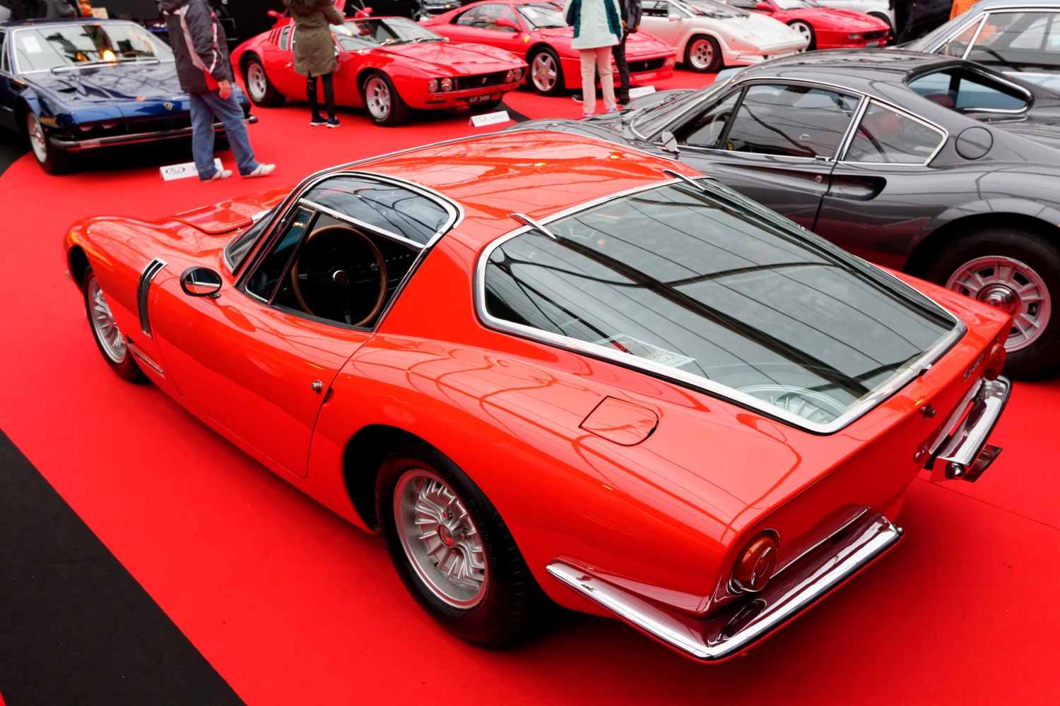 Rear and side profile with large rear window of a 1960s classic sports coupe
