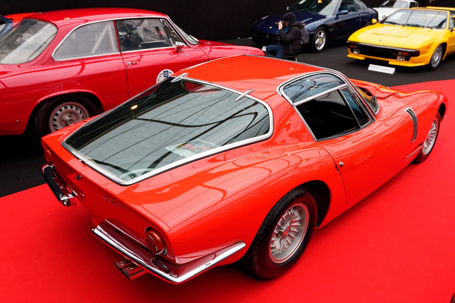 Red vintage sports coupe with distinctive fastback rear window and chrome accents
