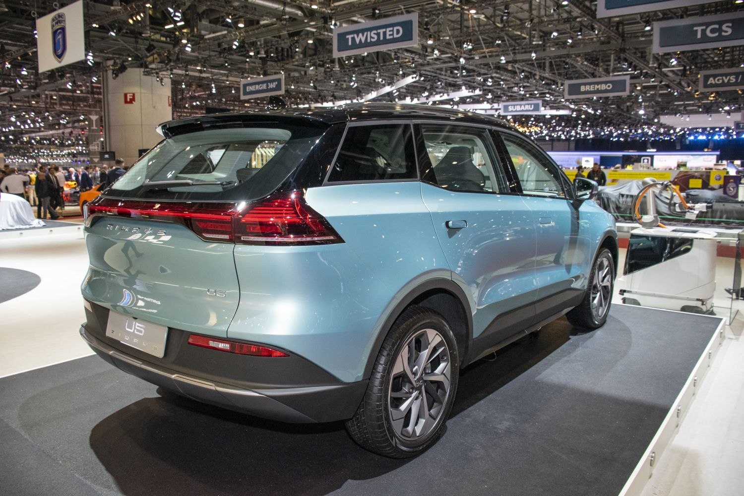 Electric SUV rear and side view with illuminated taillights and alloy wheels