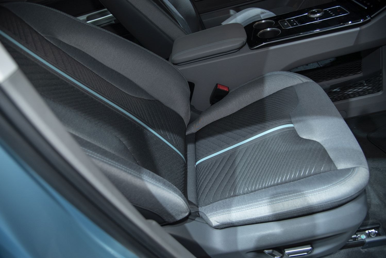 Front seat upholstery with stitching and center console controls