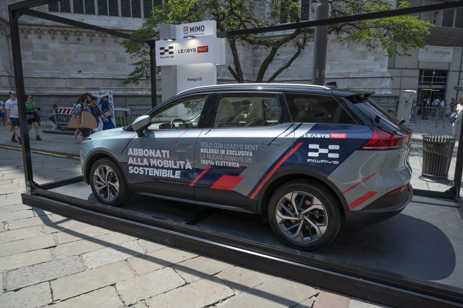 Side view of electric SUV with sustainable mobility promo wrap