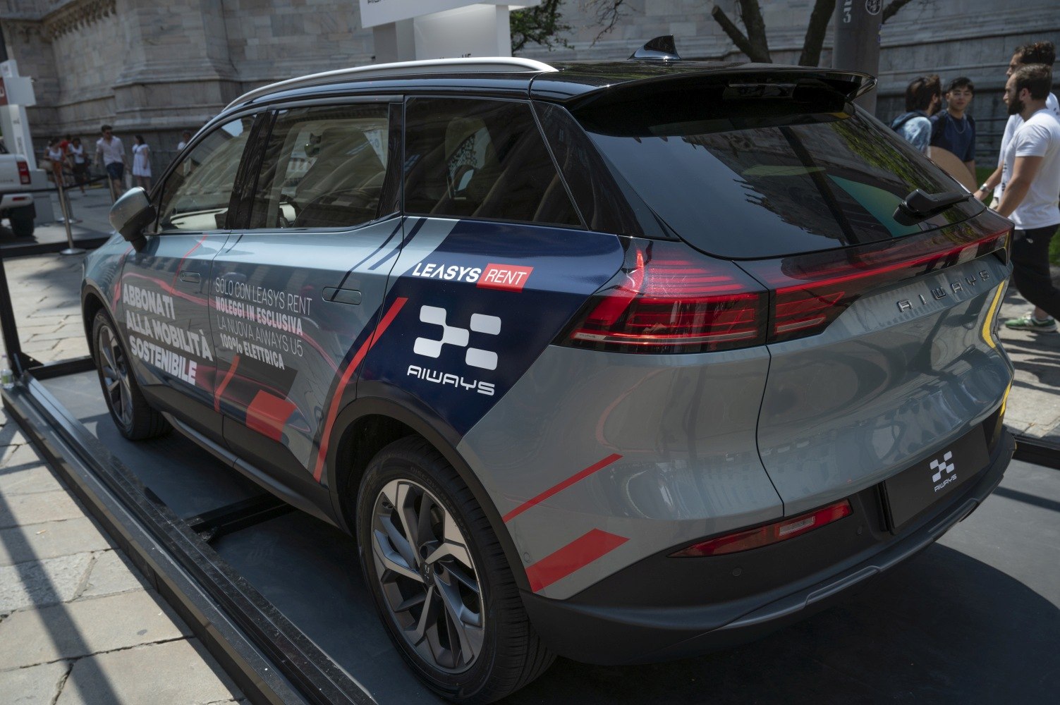 Rear and side view of electric SUV with modern tail lights and branding decals