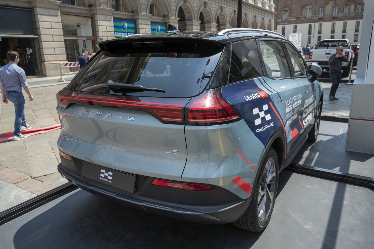 Rear hatchback design with continuous LED taillight strip and rear windshield wiper.