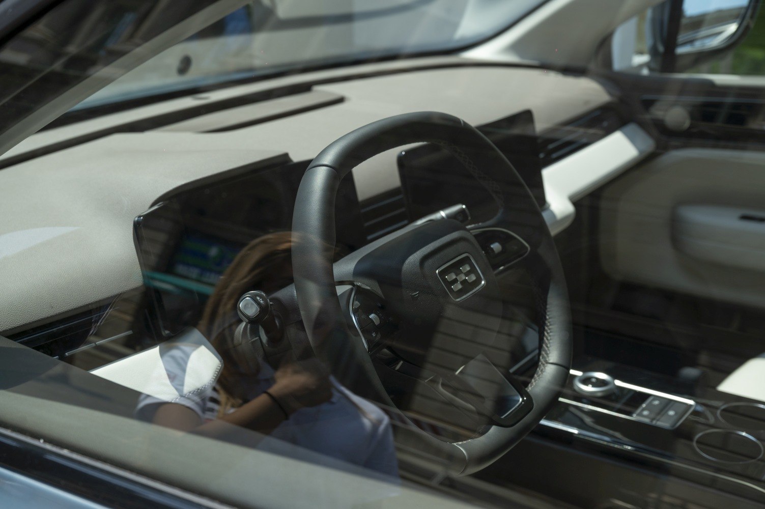 Modern steering wheel and sleek central control panel in a vehicle interior.