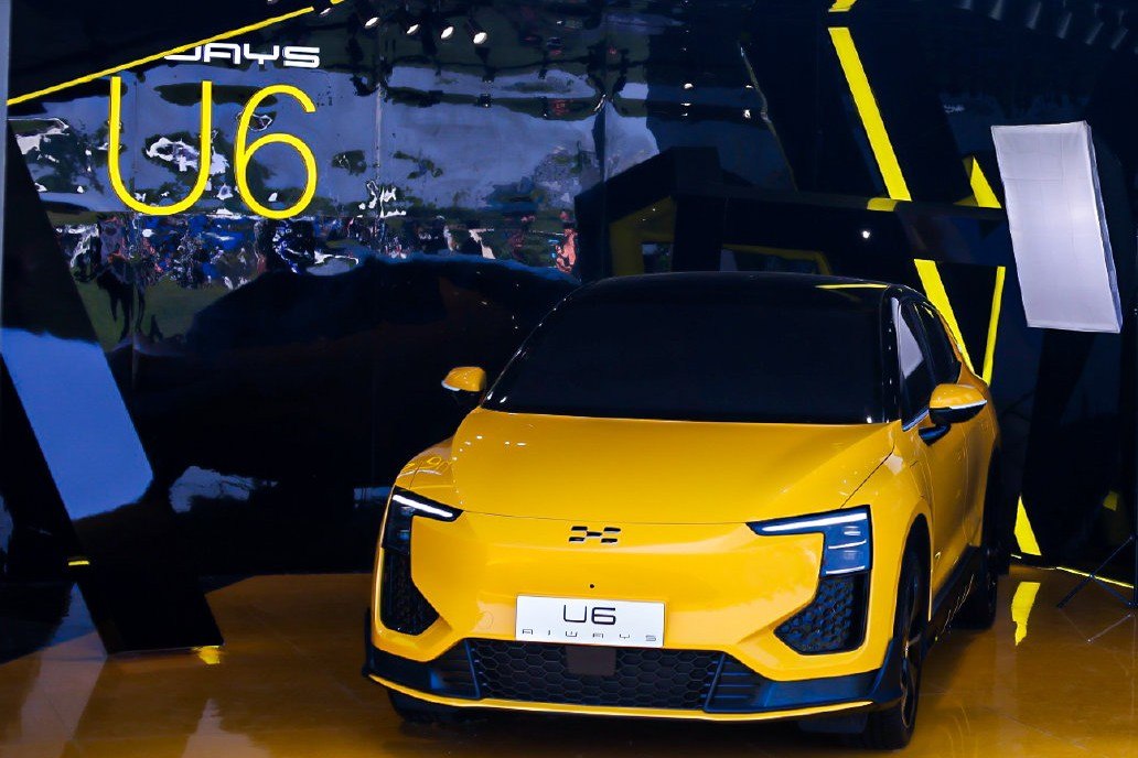 Front view of yellow electric SUV with sleek LED headlights
