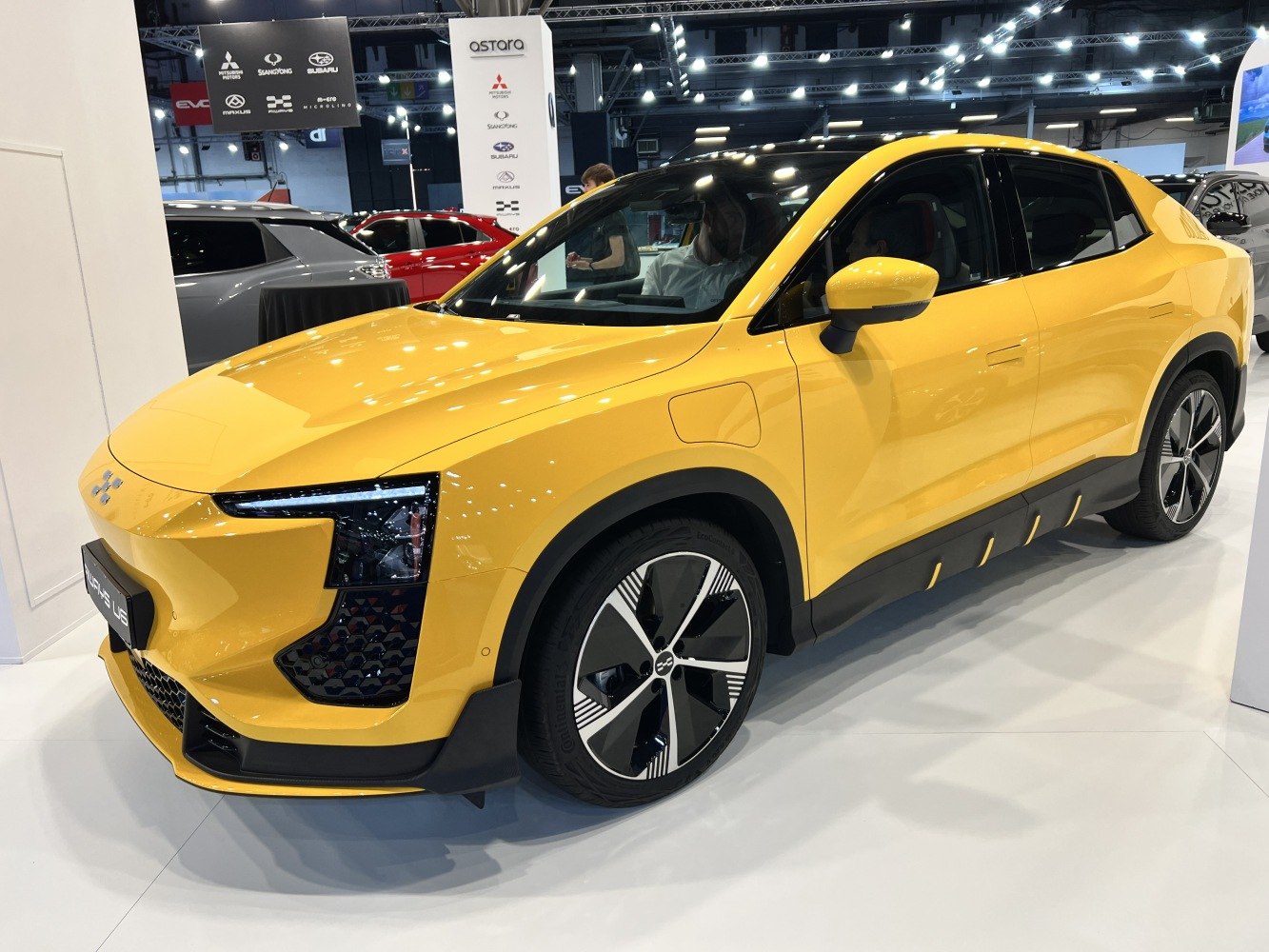Yellow electric crossover with sharp LED headlights and aerodynamic body