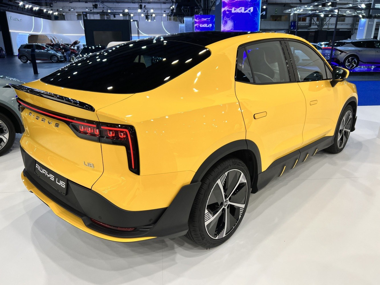 Rear three-quarter view with distinctive LED tail lights and black roof.