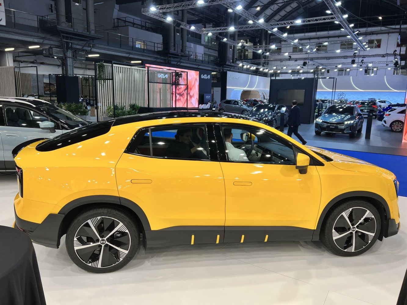 Yellow electric SUV with black roof and stylized alloy wheels side view