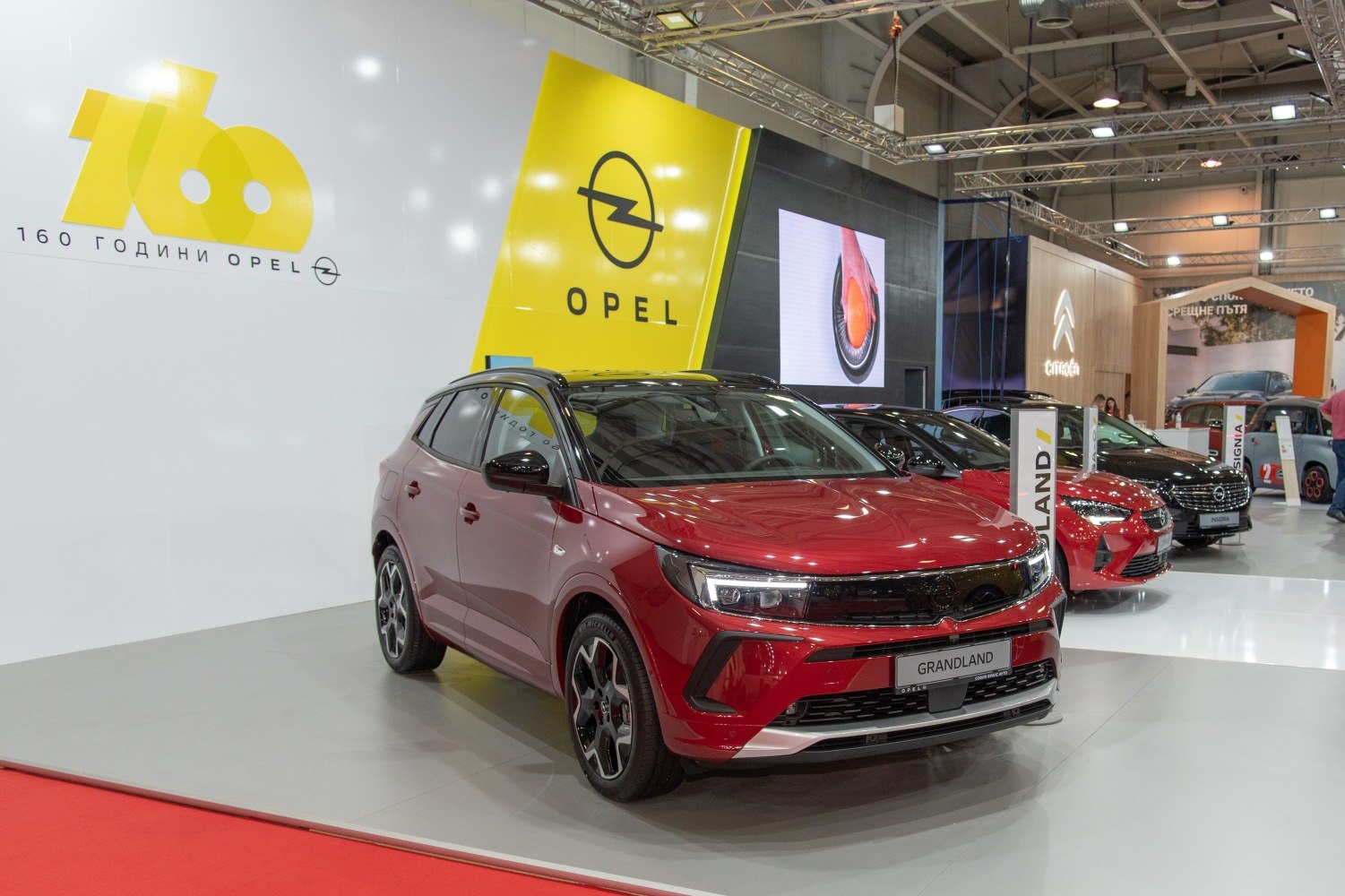 Sleek red SUV with sharp LED headlights and modern front grille
