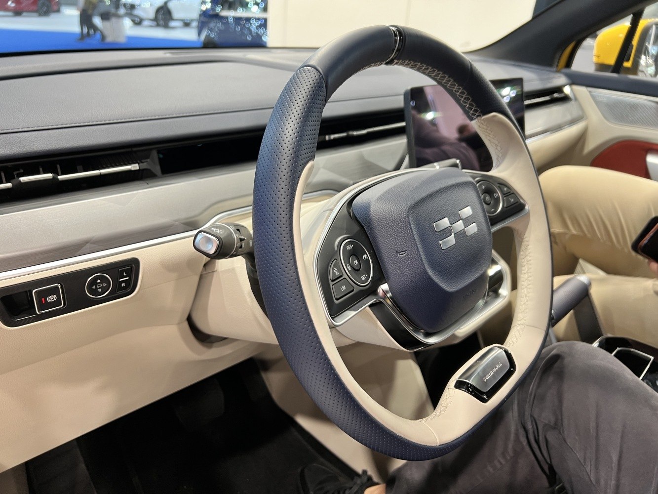 Two-tone steering wheel with control buttons and digital dashboard