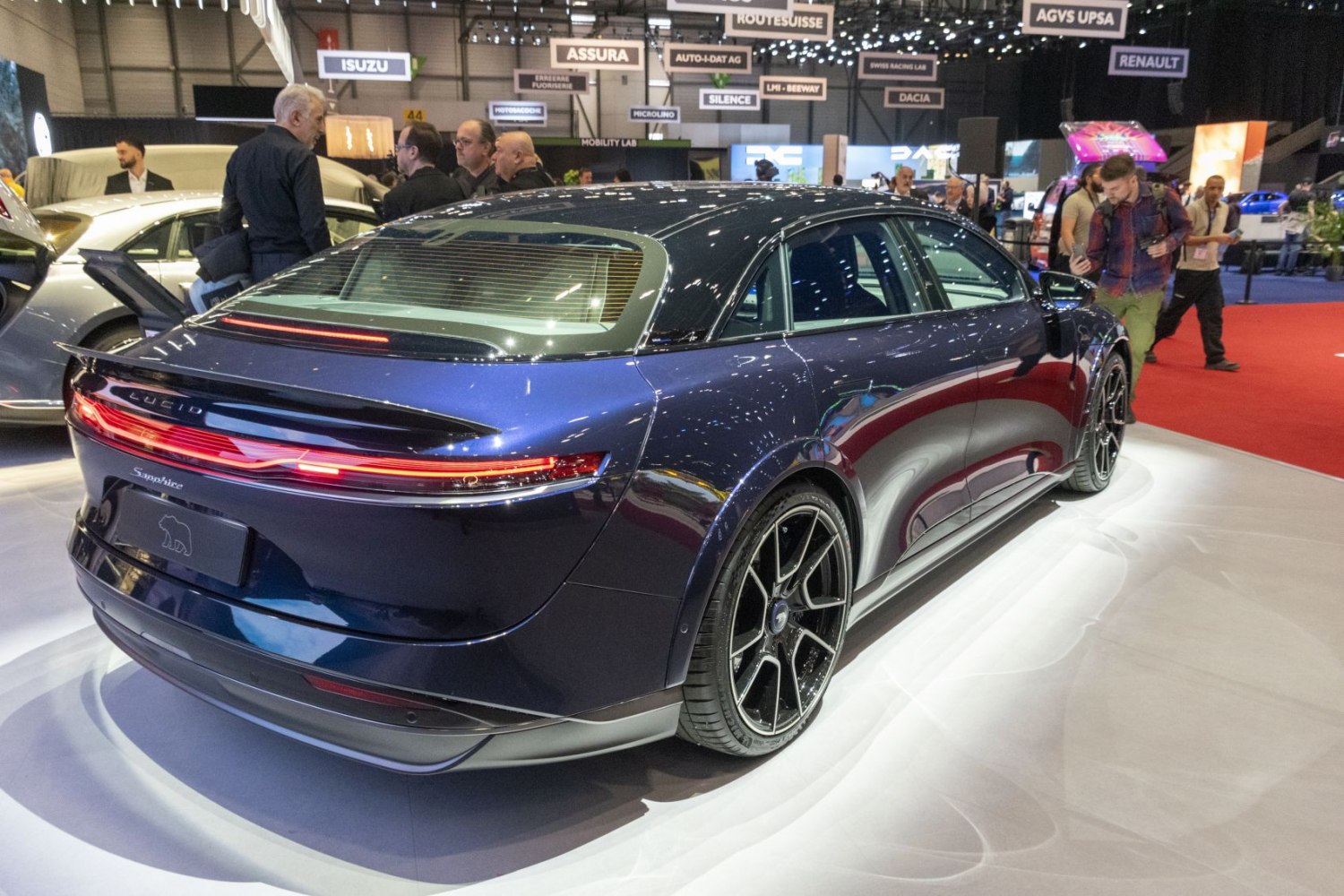 Rear view with continuous LED tail light and black multi-spoke alloy wheels