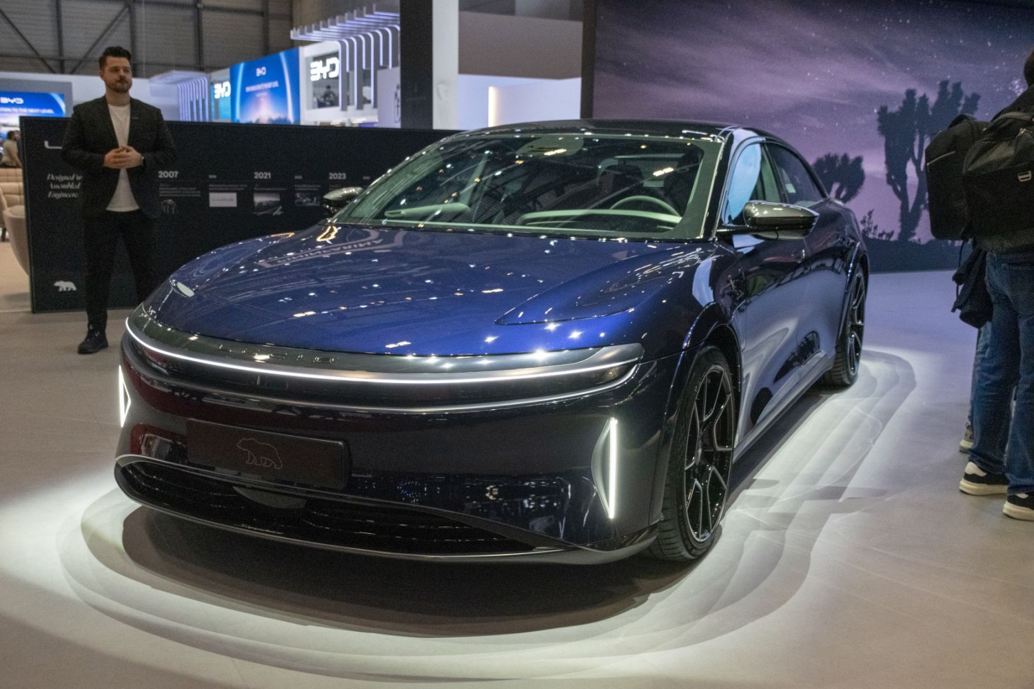 Front angle of sleek luxury electric sedan with LED lighting and aerodynamic styling