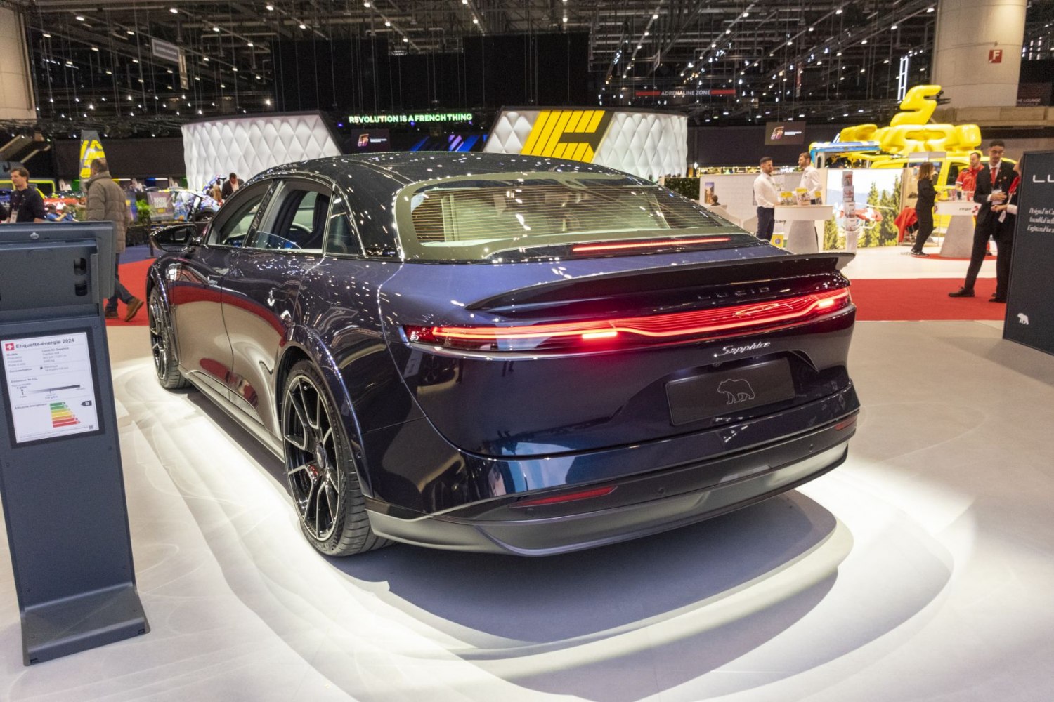 Rear view of a luxury electric sedan with sleek LED taillights and aerodynamic design