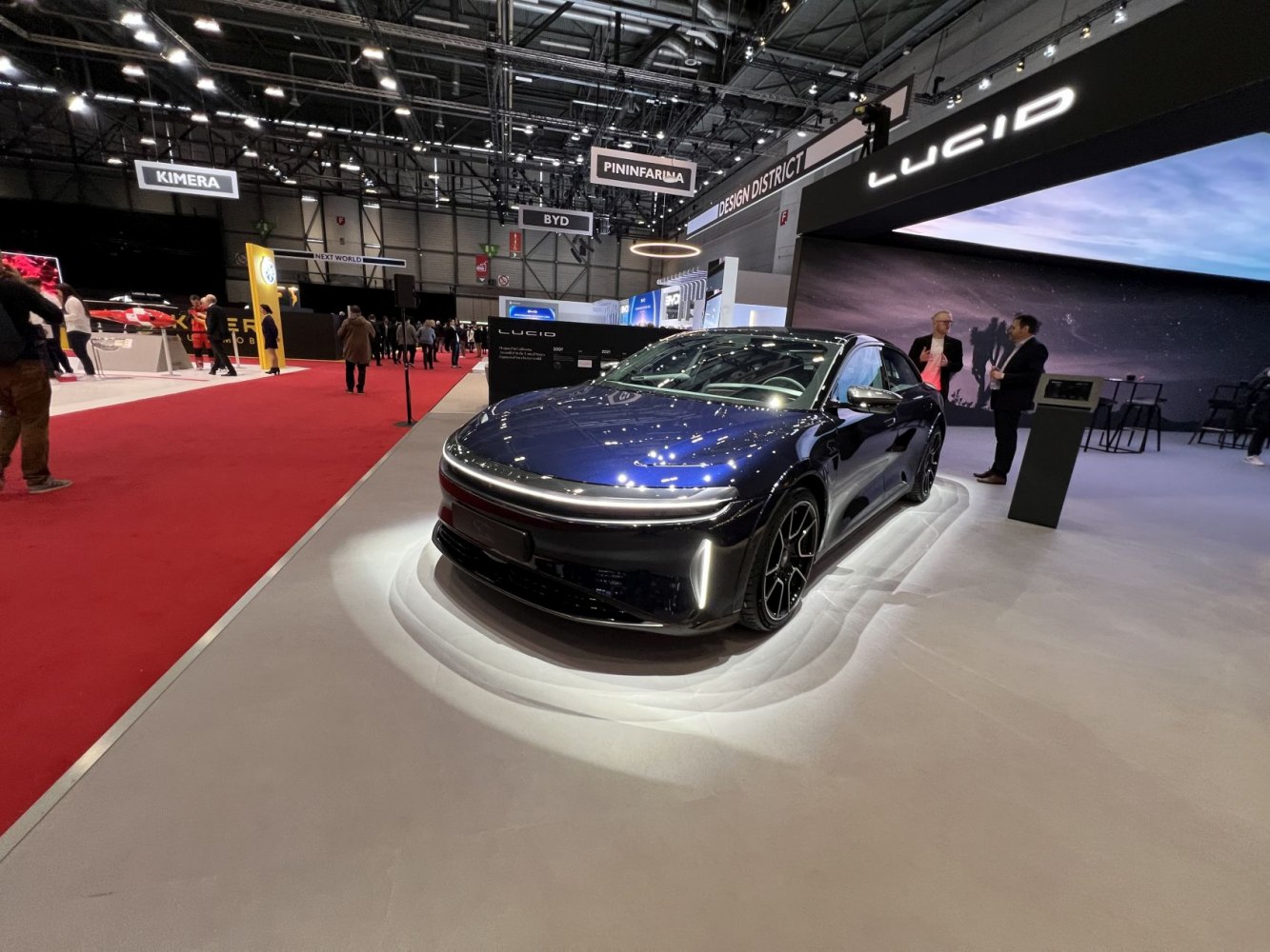 Electric vehicle with horizontal LED light strip and multi-spoke alloy wheels