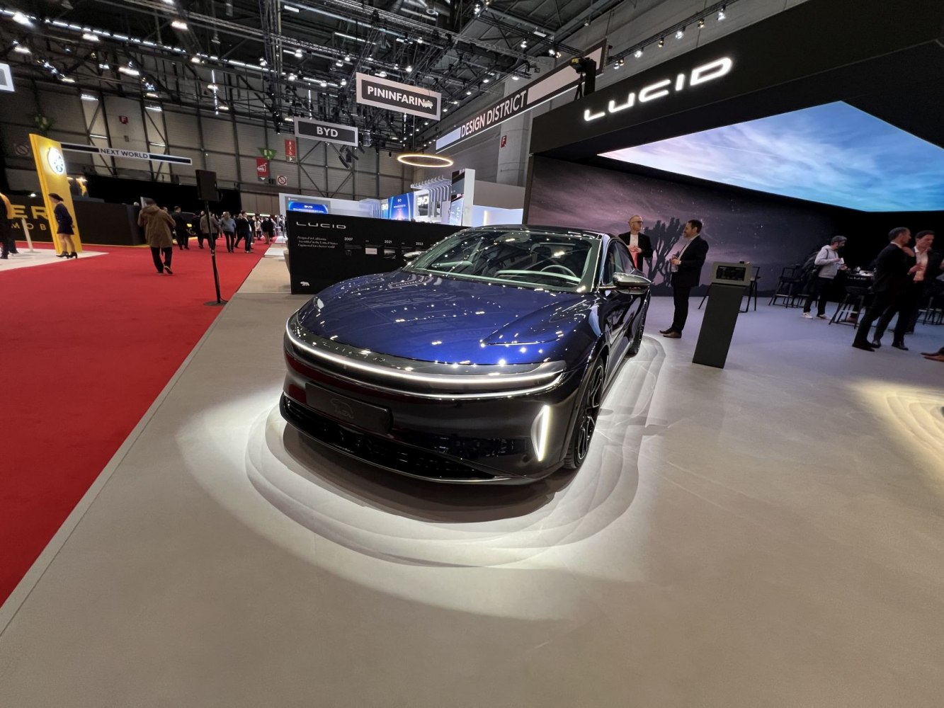 Front view of sleek electric sedan with LED lighting and aerodynamic bonnet.