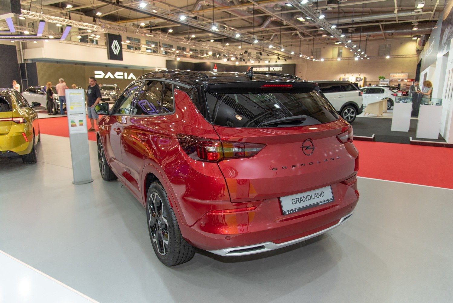 Rear view of a red SUV with updated taillights and dual exhaust details.