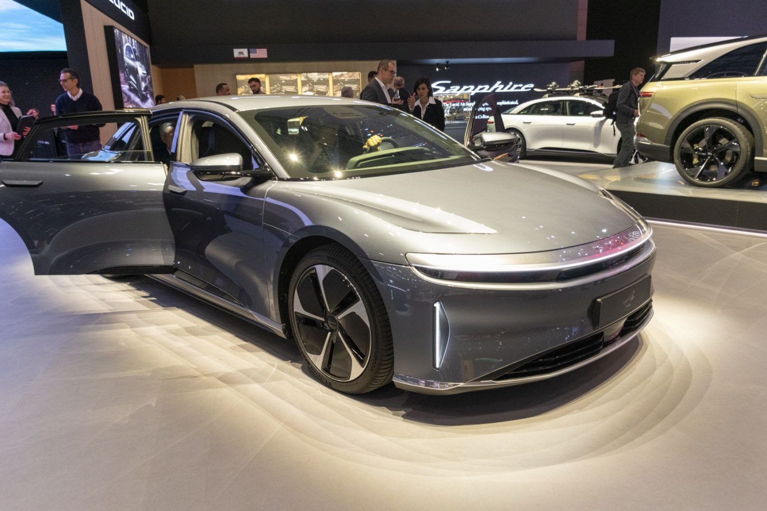 Sleek electric sedan front with LED daytime running lights and aerodynamic design.