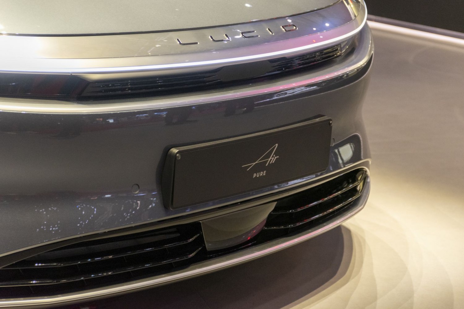 Close-up of sleek Lucid Air front grille and badge