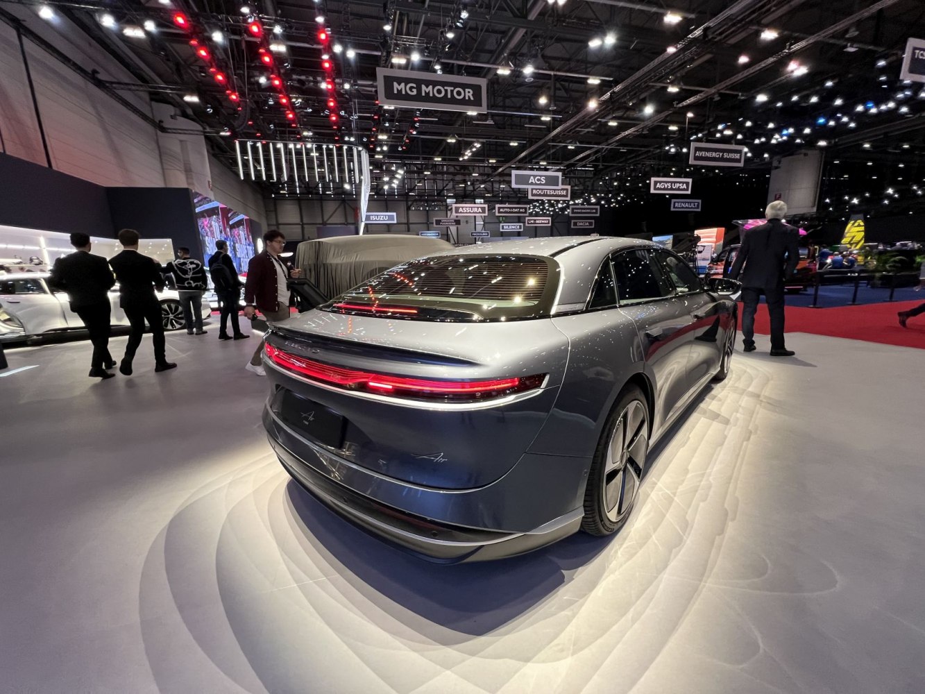 Rear view of sleek sedan with full-width red LED tail light.