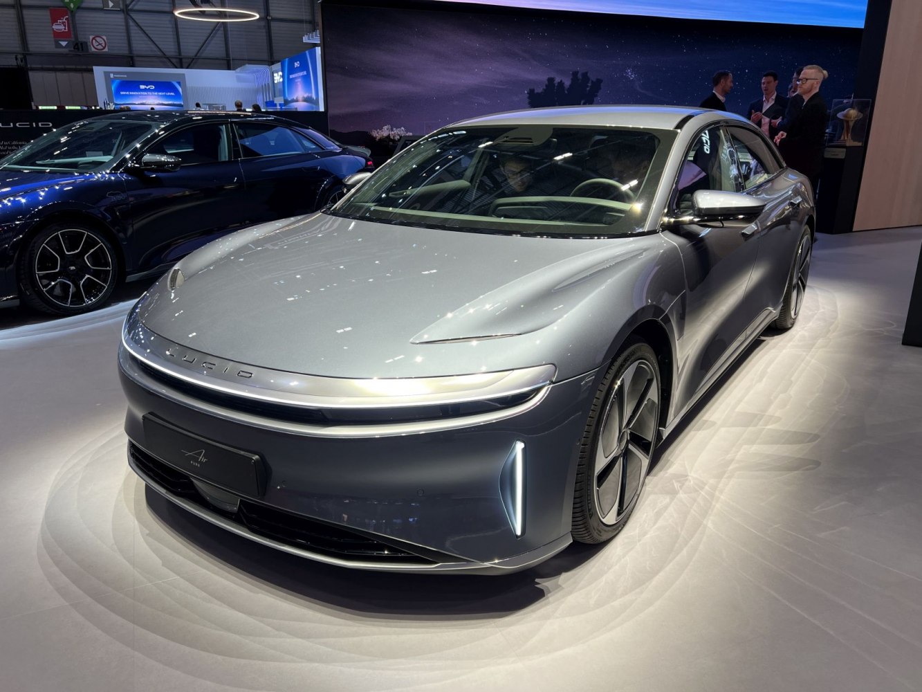 Sleek electric sedan with slim LED headlights and vertical DRLs.