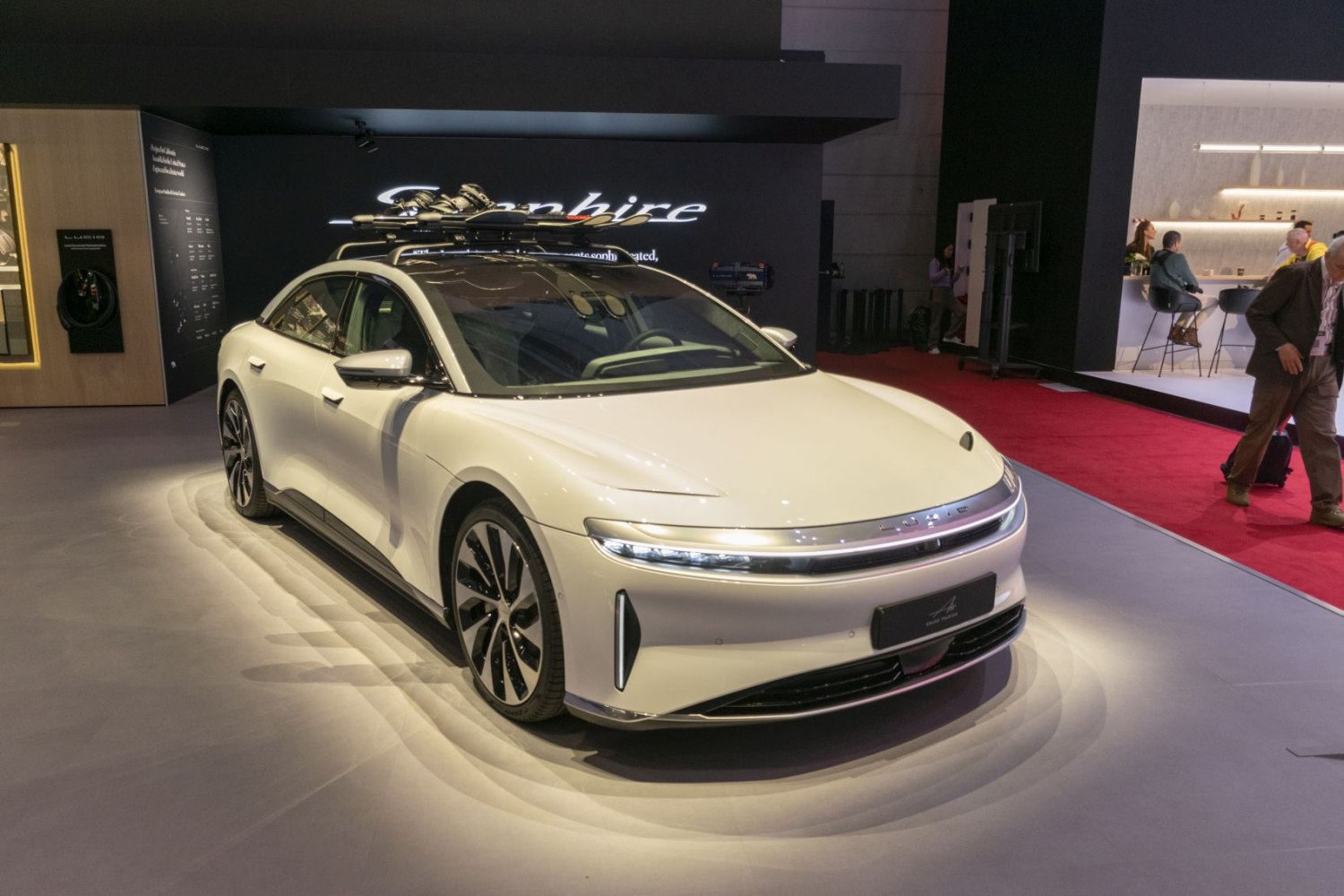 Front angle of electric sedan with LED headlights and roof ski rack