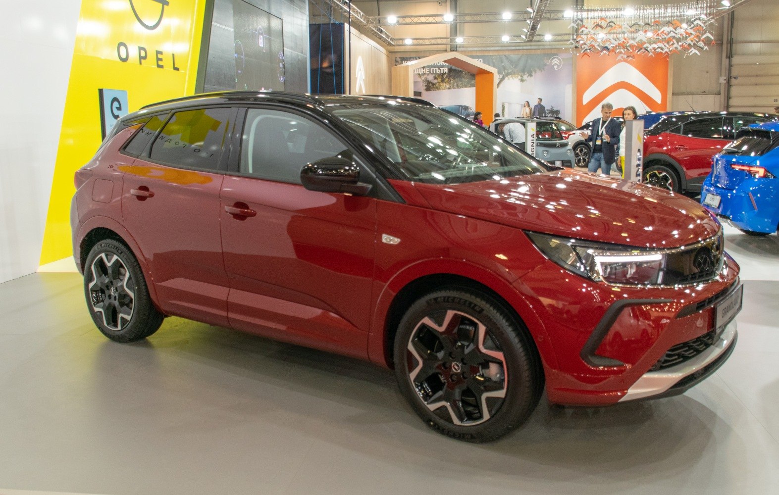 Red compact SUV side profile with LED headlights and modern alloy wheels
