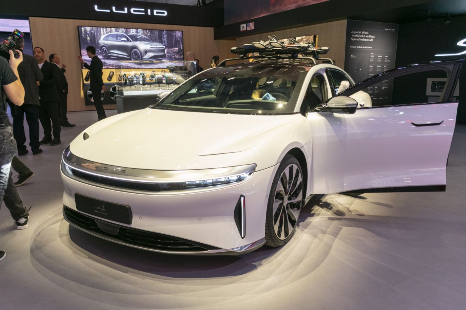 Front view of a 2022 electric sedan with sleek LED headlights and roof rack.