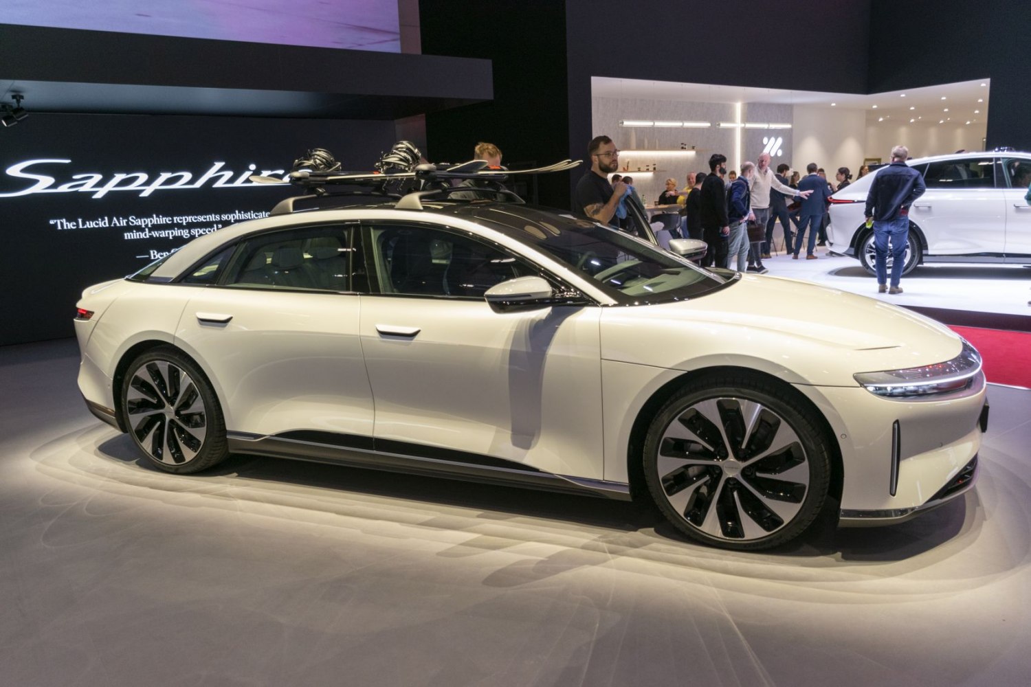 Electric sedan with roof rack and multi-spoke alloy wheels