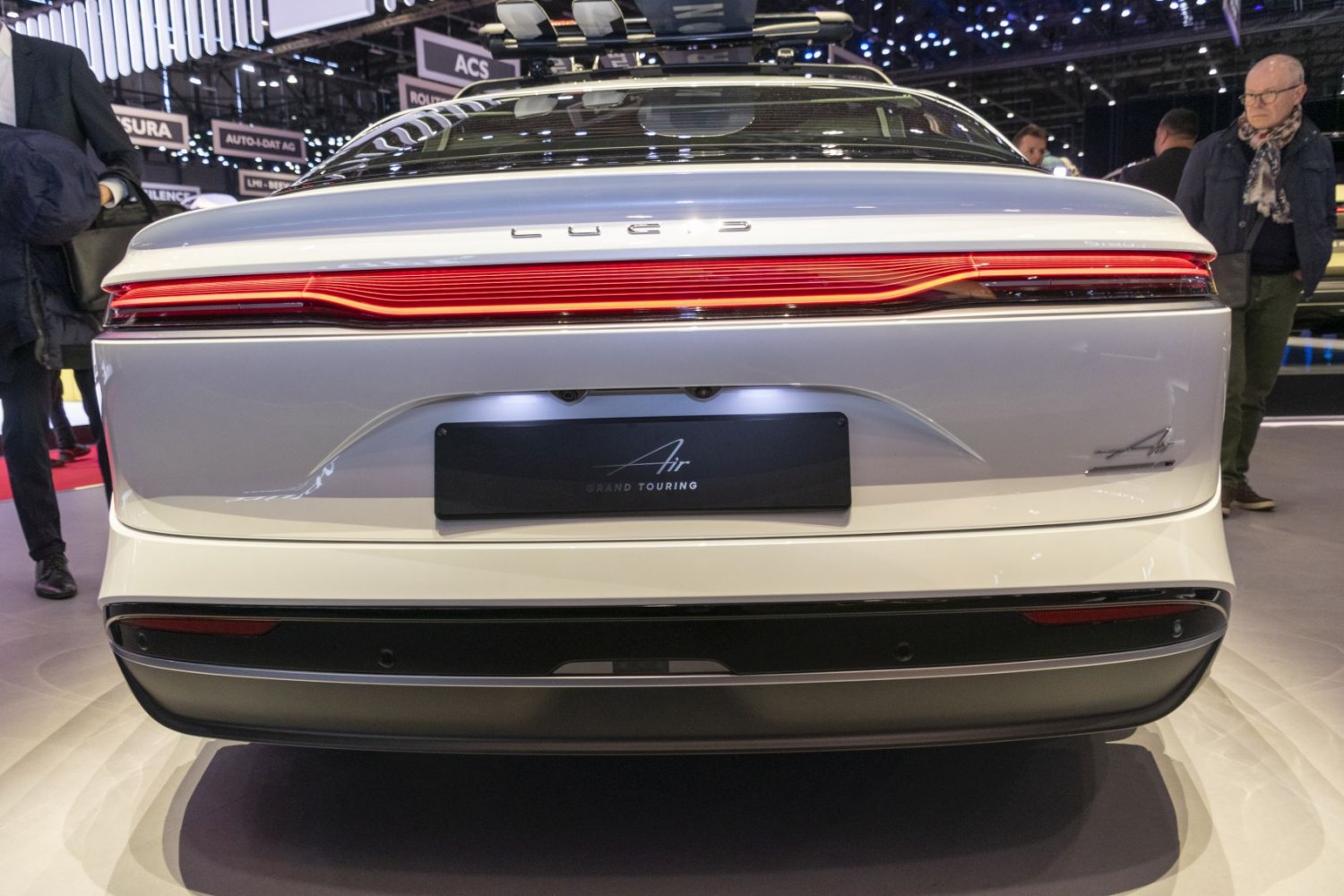 Rear tail light and bumper design with illuminated license plate area