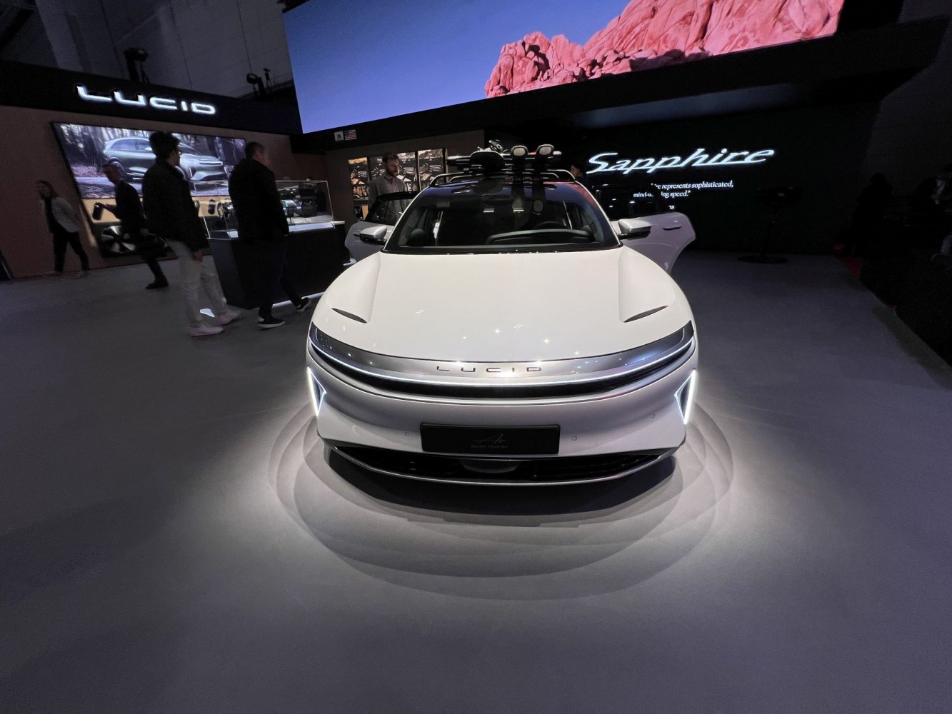 Front view of sleek electric vehicle with LED lights and aerodynamic hood