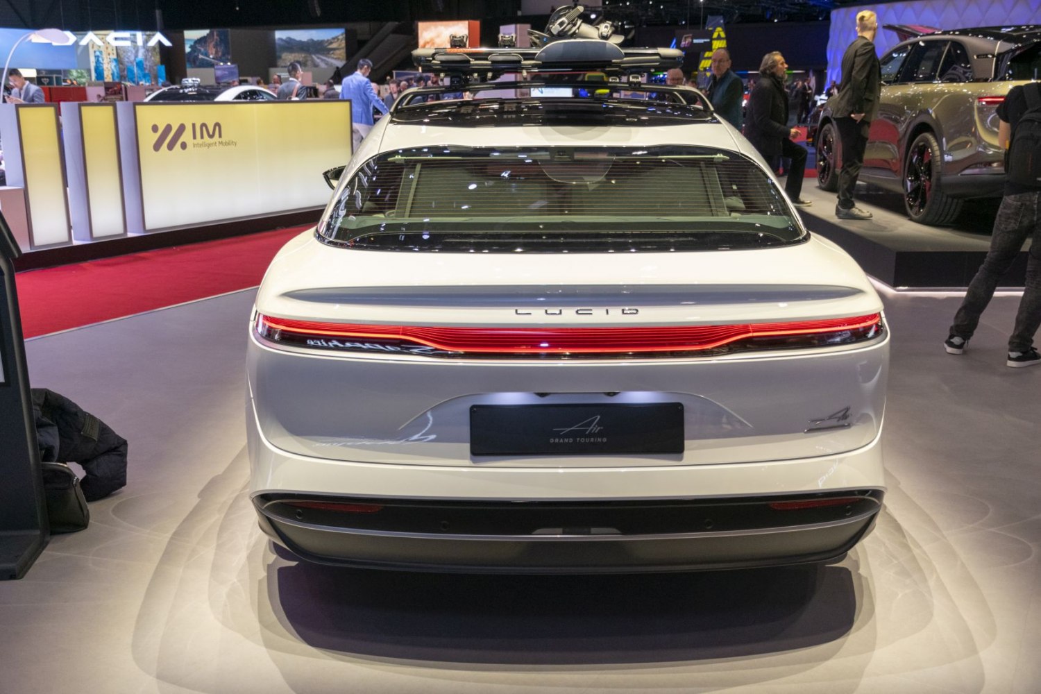 Rear view of electric sedan with roof ski rack and continuous tail light