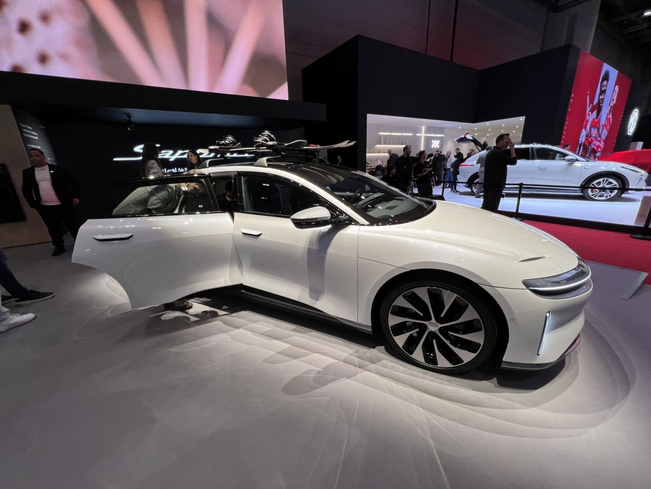 Electric sedan with roof ski rack and modern alloy wheels