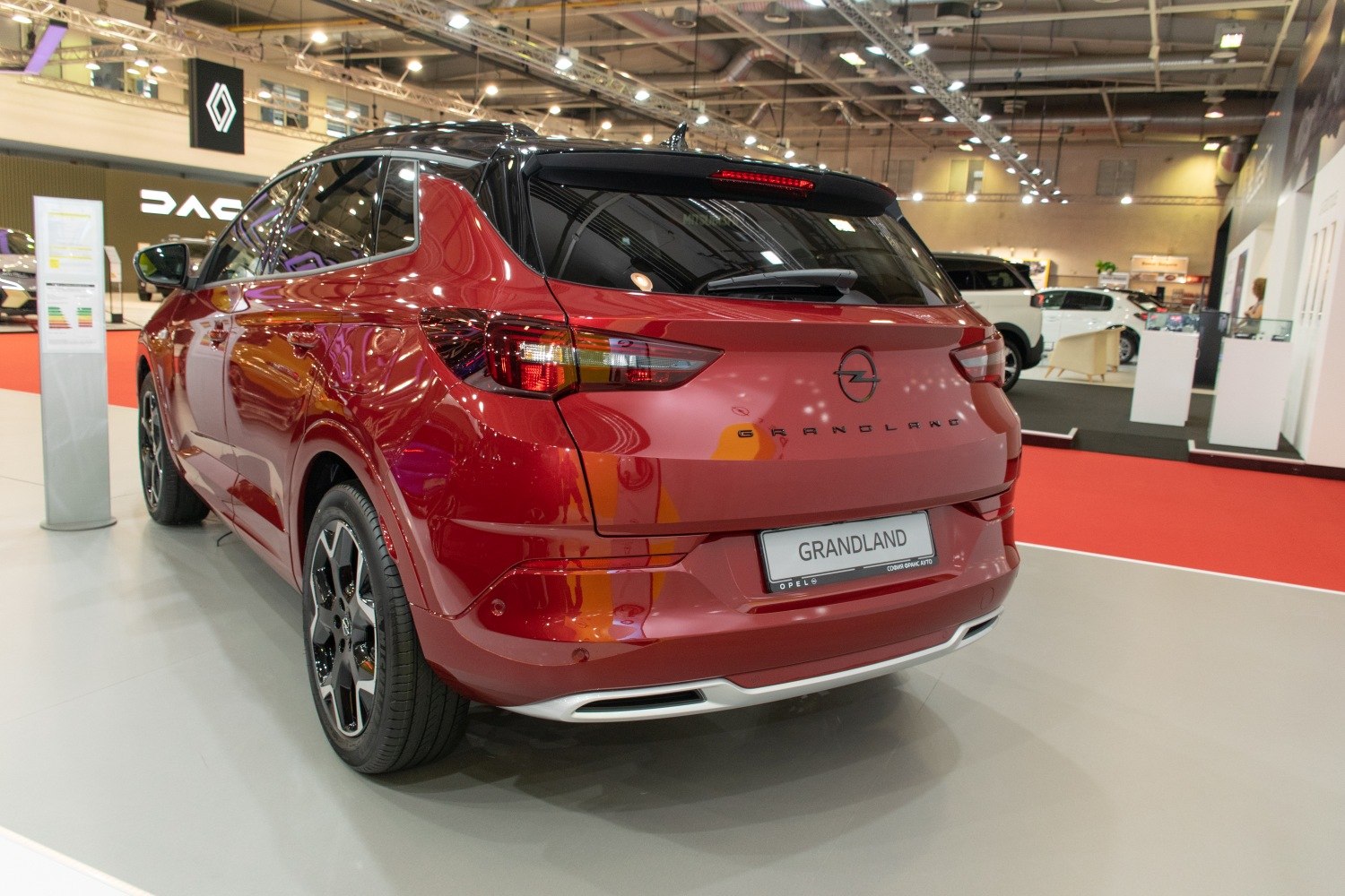 Rear view of red crossover with modern taillights and black roof