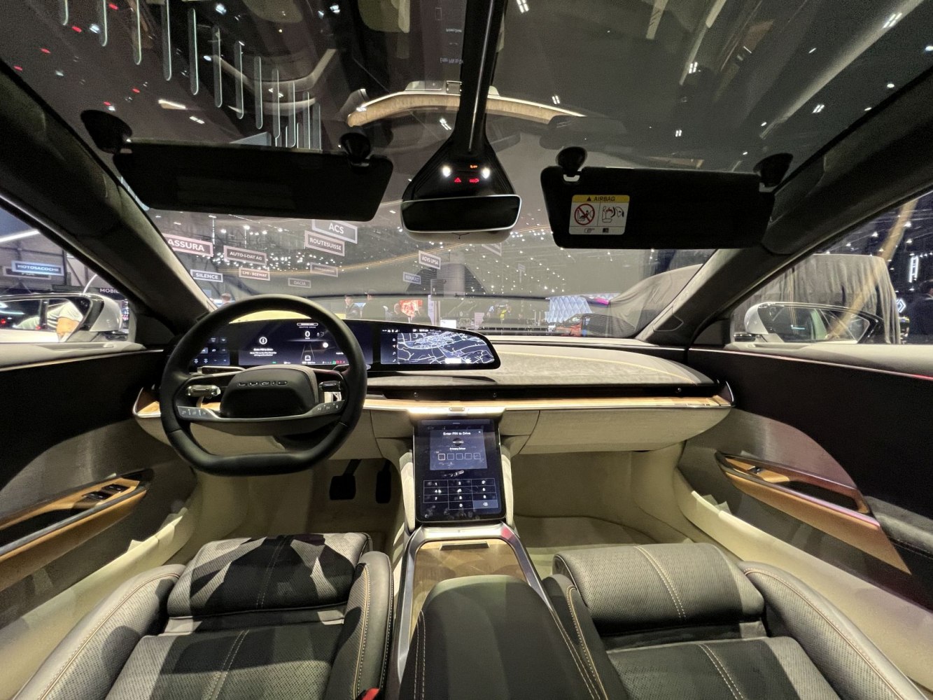 Futuristic dashboard and steering wheel with digital displays and touchscreen controls