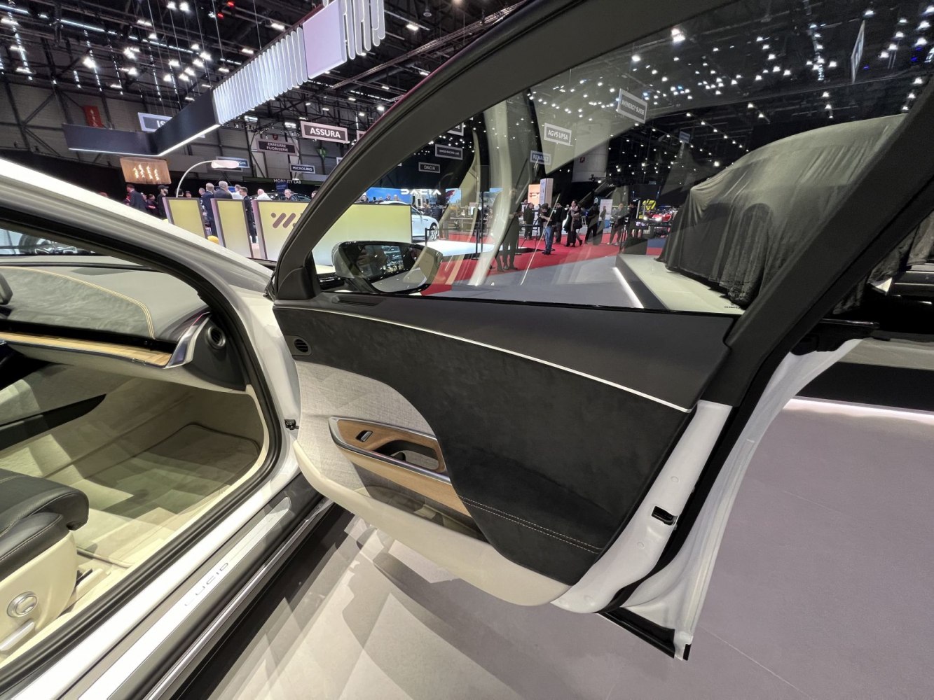 Interior door panel with wood trim and stitched leather