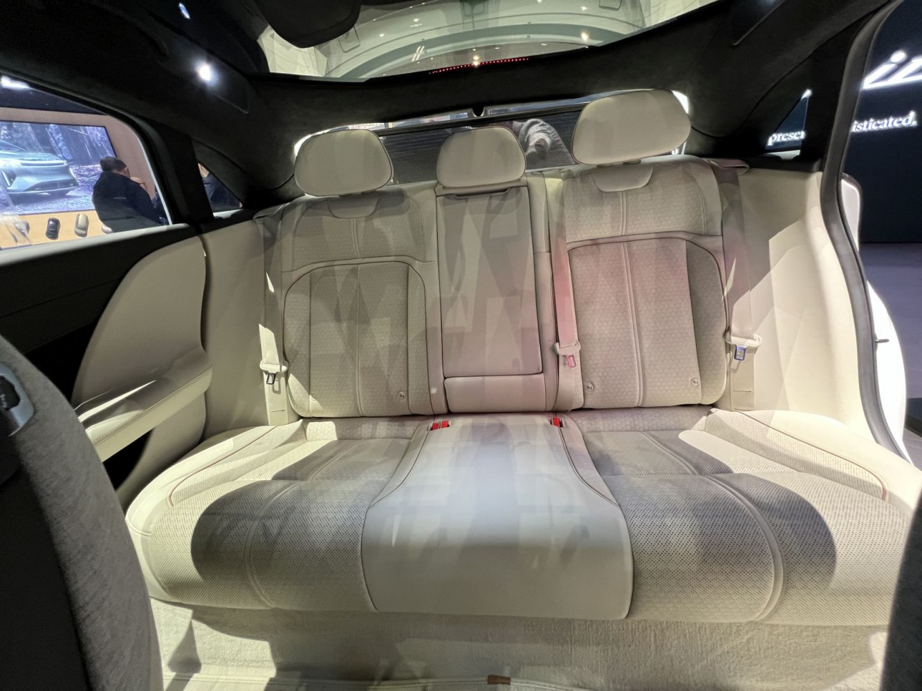 Plush rear seating with three headrests and detailed upholstery