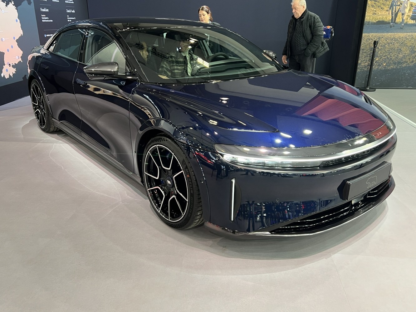 Sleek electric sedan with aerodynamic body and multi-spoke alloy wheels