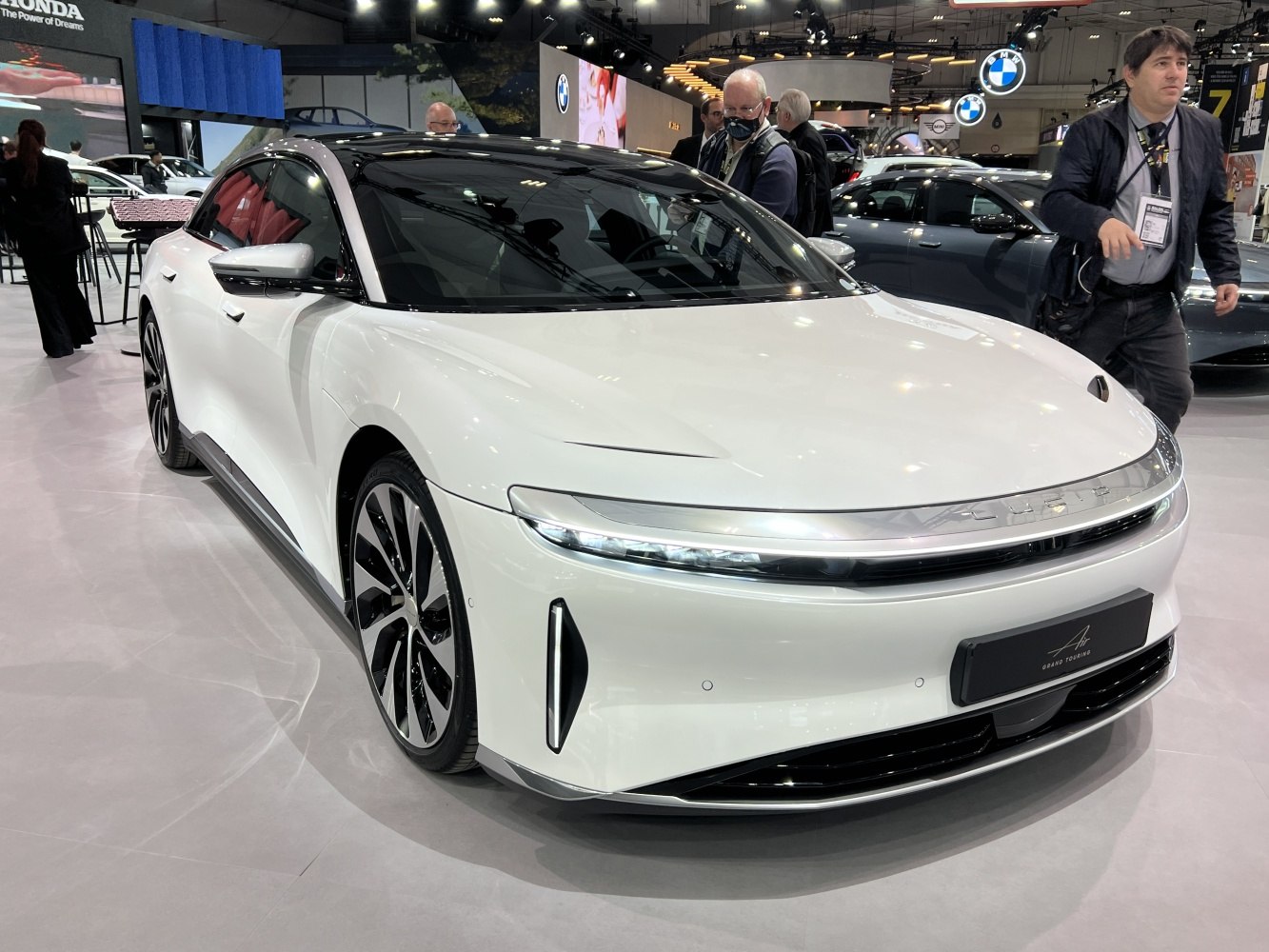 Sleek electric sedan front with panoramic glass roof and LED lighting.