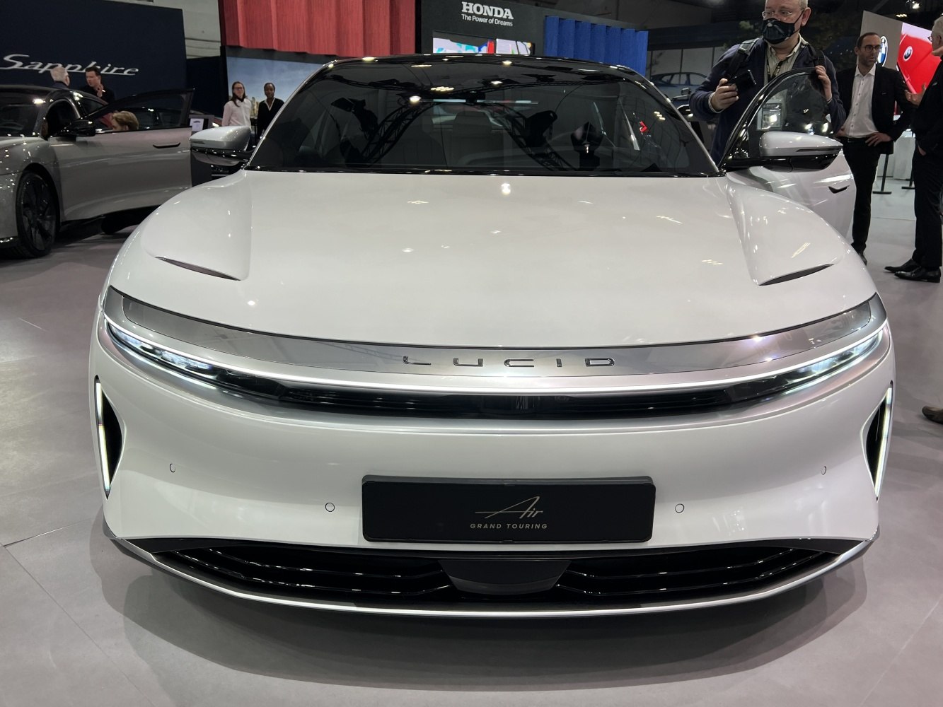 Front view of sleek electric luxury sedan with LED lights