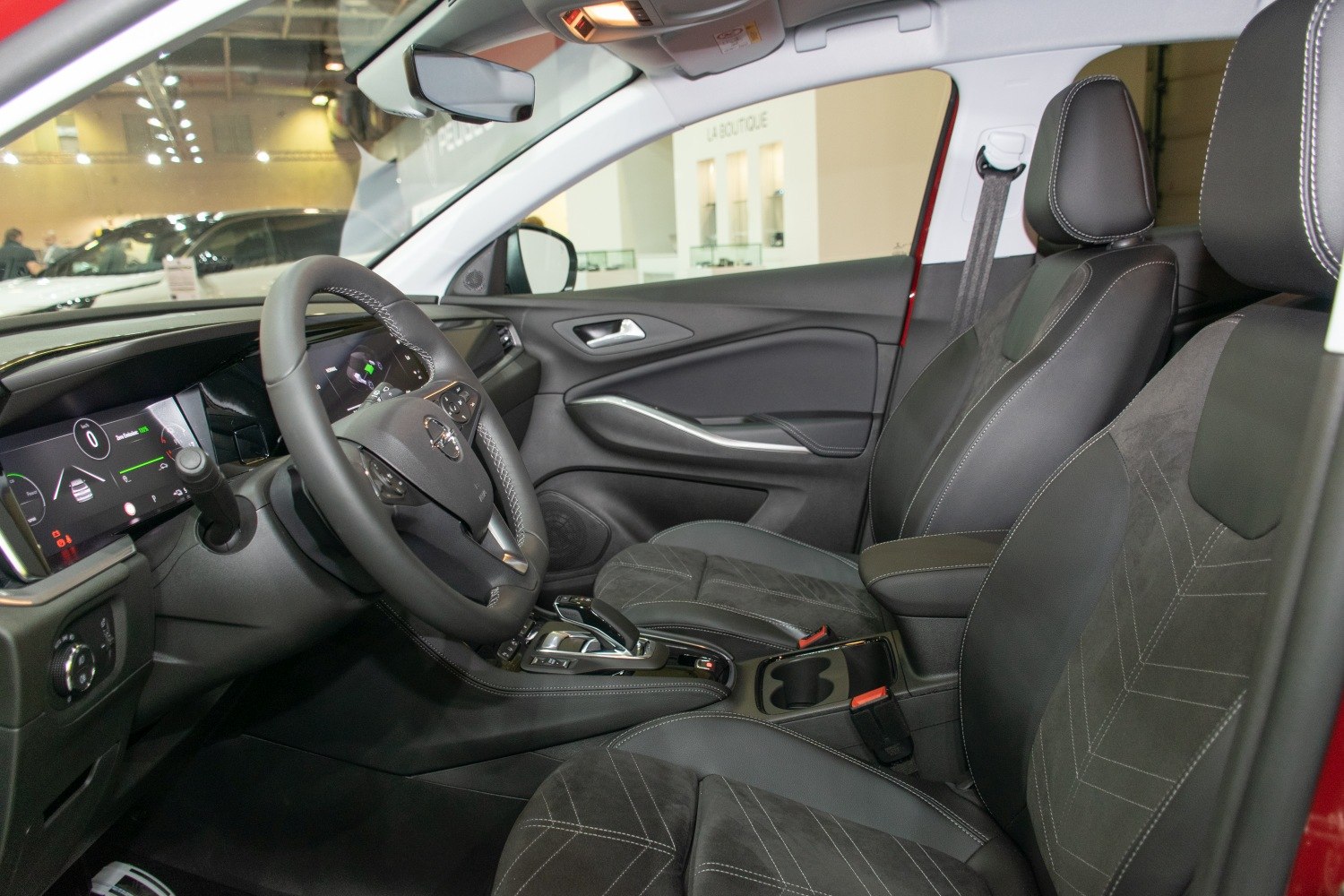 Modern dashboard with digital displays and comfortable front seats with stylish stitching