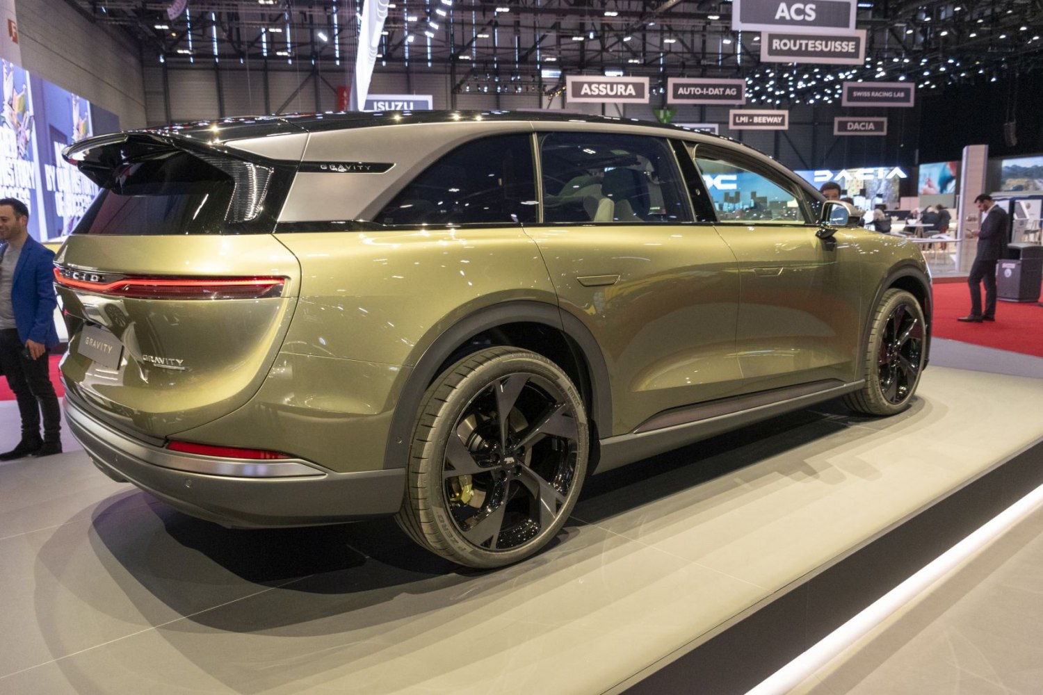 Rear side view of a sleek electric SUV with modern tail lights and sporty wheels.