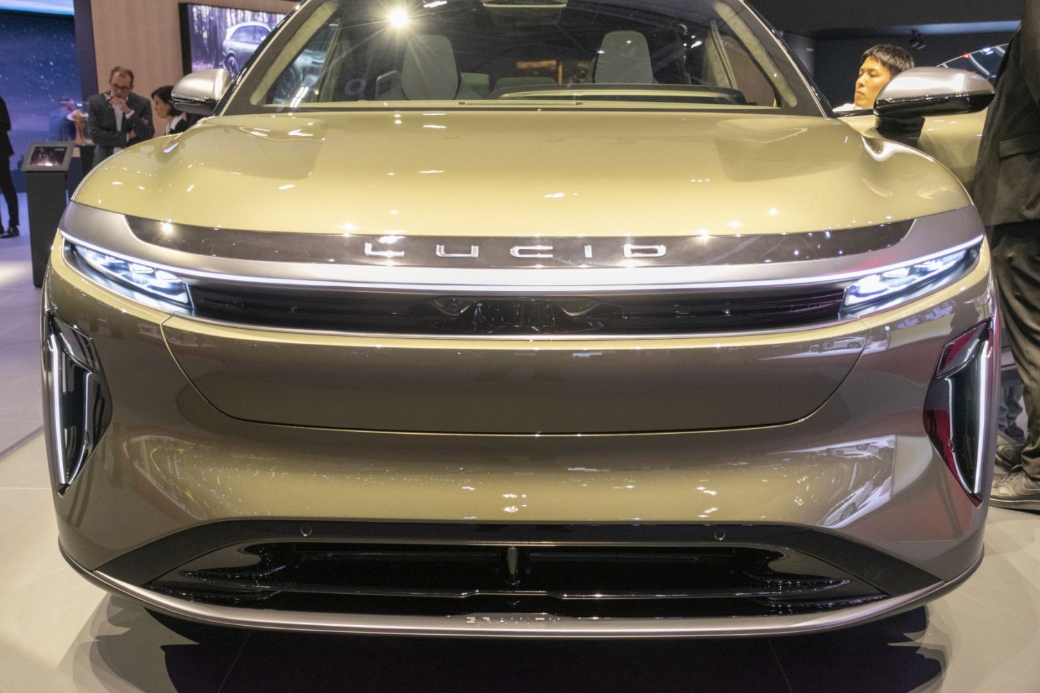 Front view of a sleek modern electric vehicle with LED headlights and aerodynamic grille.