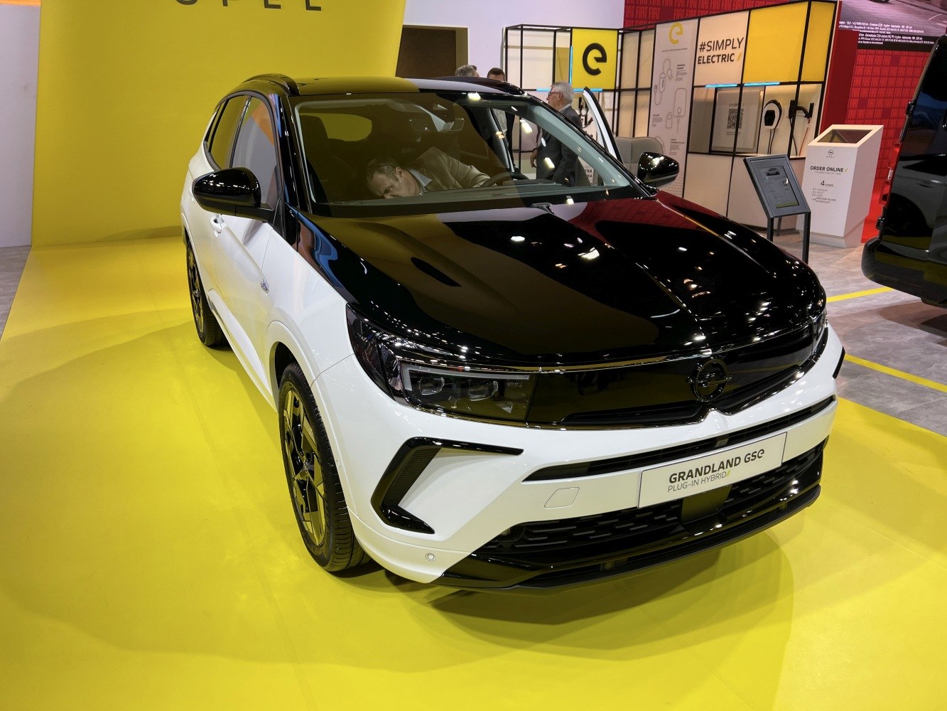 Front view of a two-tone black and white modern SUV with plug-in hybrid badge